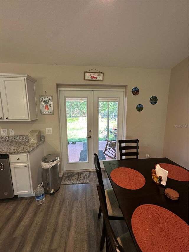 dining area featuring baseboards, dark wood finished floors, and french doors