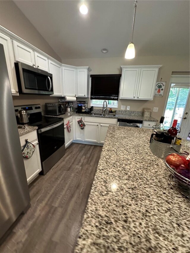 kitchen featuring a sink, appliances with stainless steel finishes, white cabinets, and dark wood-type flooring