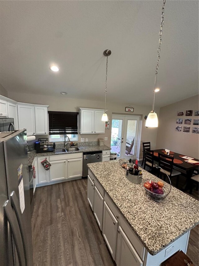 kitchen featuring french doors, dark wood-style flooring, dishwasher, a sink, and freestanding refrigerator