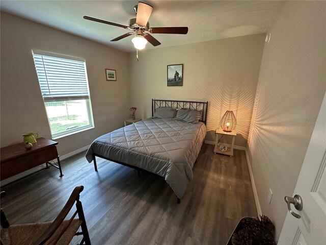 bedroom featuring baseboards, ceiling fan, and wood finished floors