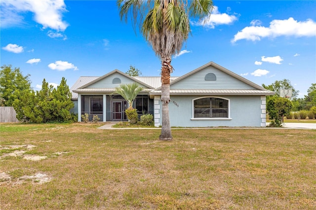 6045 SE 99th Pl, Belleview, FL 34420 - single story home with stucco siding, a sunroom, metal roof, and a front yard