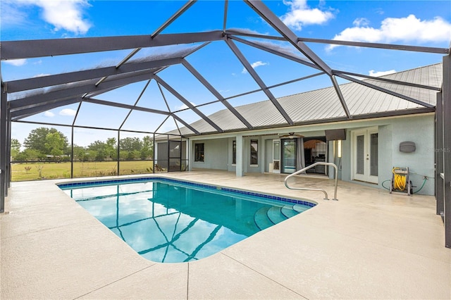 6045 SE 99th Pl, Belleview, FL 34420 - pool with glass enclosure, a patio, a ceiling fan, and french doors