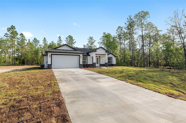 ranch-style house with driveway, a garage, a front lawn, stone siding, and stucco siding