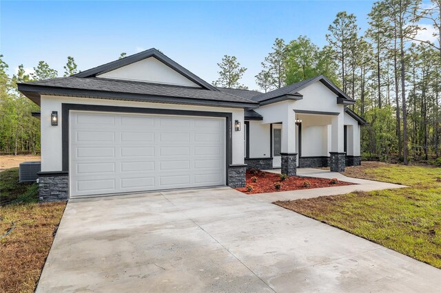 view of front of property featuring concrete driveway, cooling unit, stone siding, and stucco siding