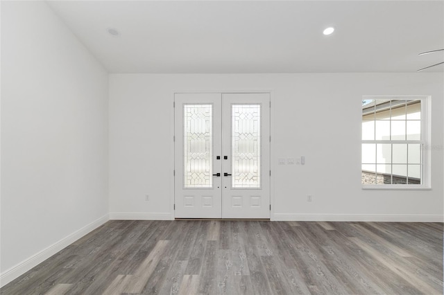foyer with french doors, baseboards, and wood finished floors