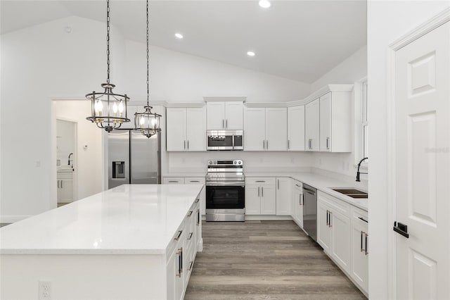 kitchen with an inviting chandelier, a sink, a center island, stainless steel appliances, and recessed lighting