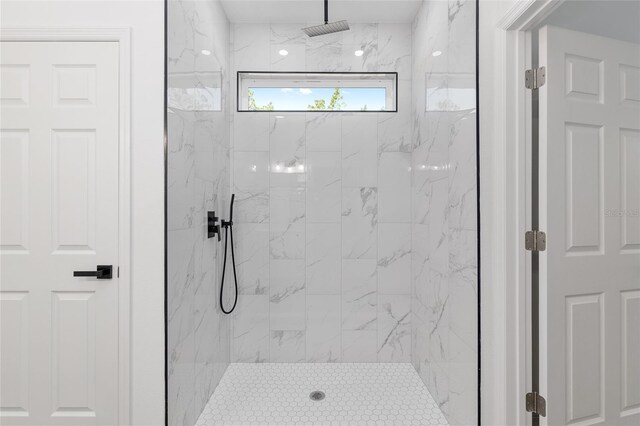 bathroom featuring a marble finish shower