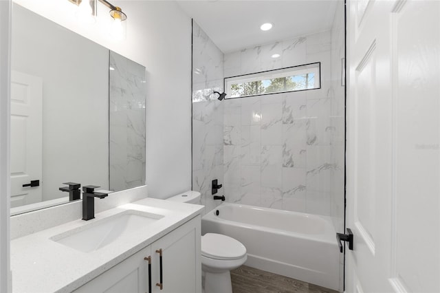 full bathroom featuring vanity, toilet, wood finished floors, and shower / washtub combination