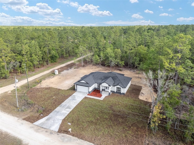 drone / aerial view featuring a view of trees