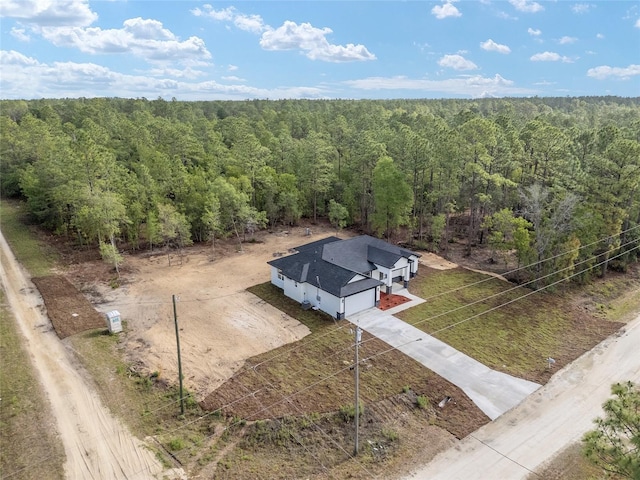 drone / aerial view featuring a forest view