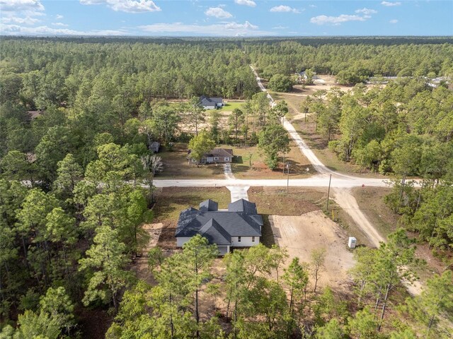 drone / aerial view featuring a forest view