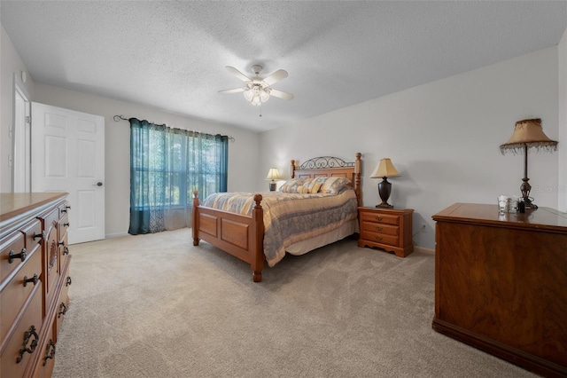 bedroom featuring a textured ceiling, light colored carpet, and baseboards