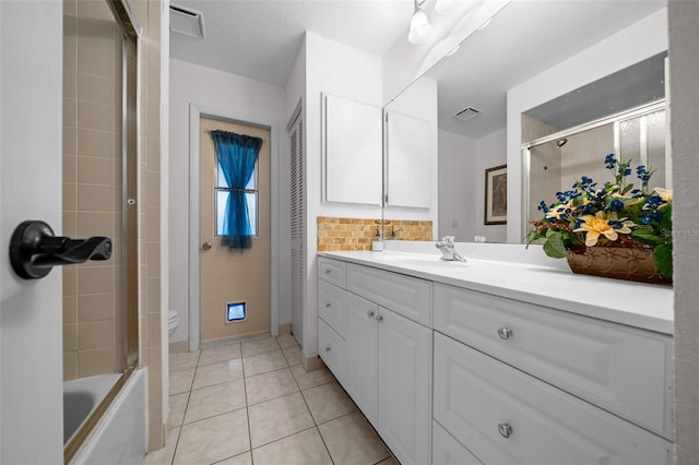 full bath featuring walk in shower, vanity, toilet, tile patterned floors, and baseboards