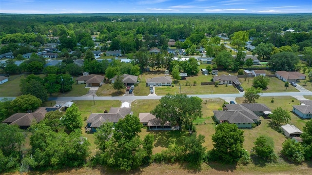 aerial view featuring a wooded view and a residential view