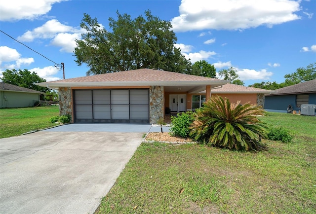 ranch-style house with driveway, stone siding, and a front lawn