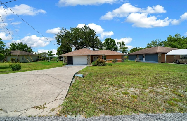 single story home featuring a garage, a front lawn, and concrete driveway