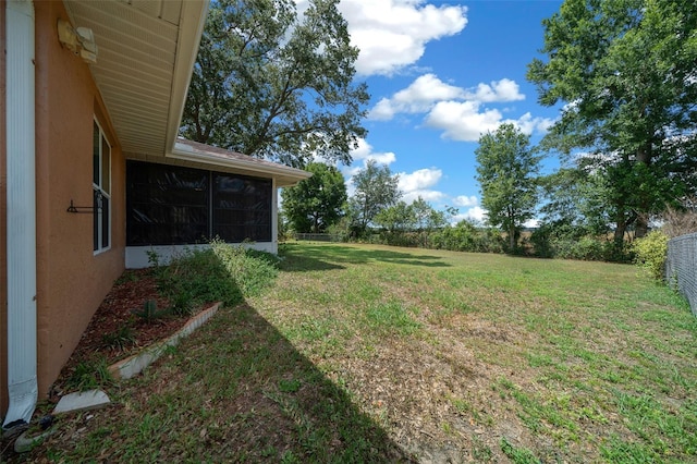view of yard with a fenced backyard and a sunroom