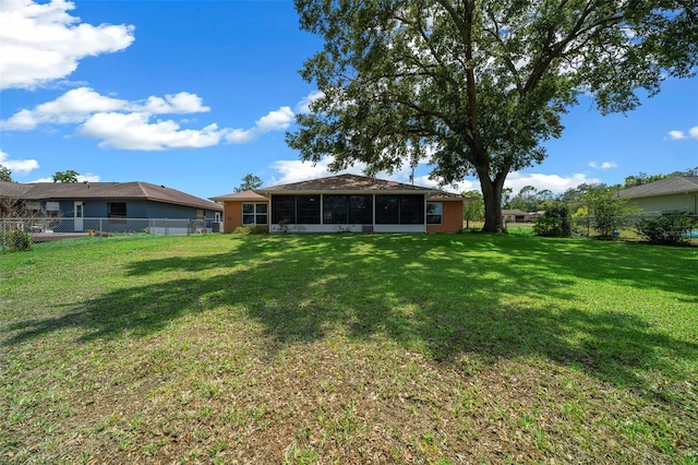 view of yard with a fenced backyard and a sunroom