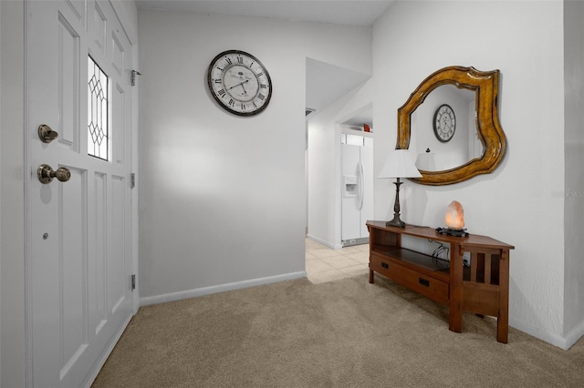 entrance foyer with light colored carpet and baseboards