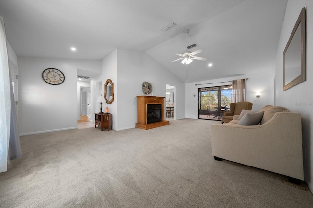 living room featuring carpet flooring, a glass covered fireplace, a ceiling fan, baseboards, and visible vents