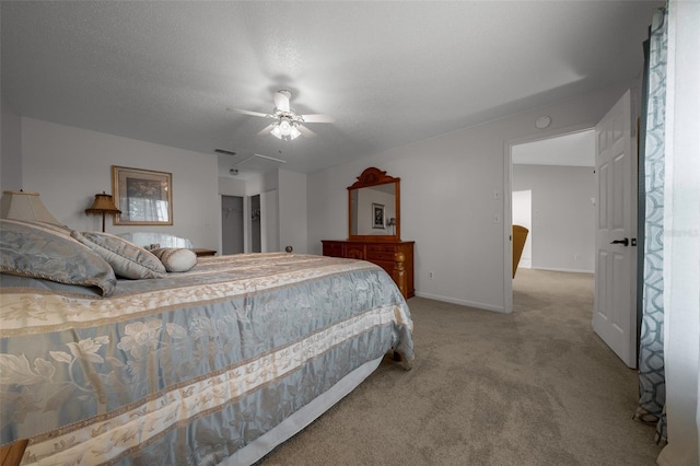 carpeted bedroom with a textured ceiling, baseboards, visible vents, and ceiling fan