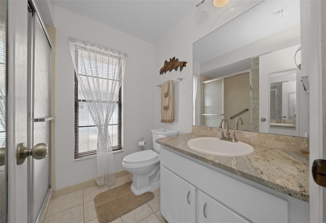 bathroom featuring toilet, visible vents, a shower stall, and a healthy amount of sunlight