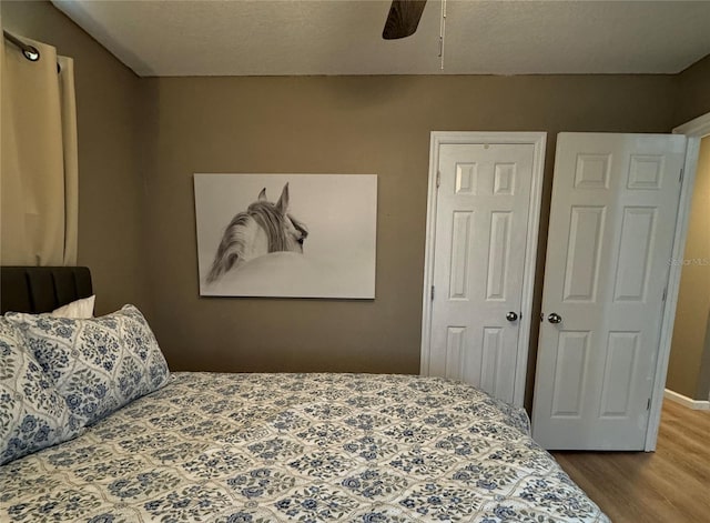 bedroom featuring ceiling fan and wood finished floors
