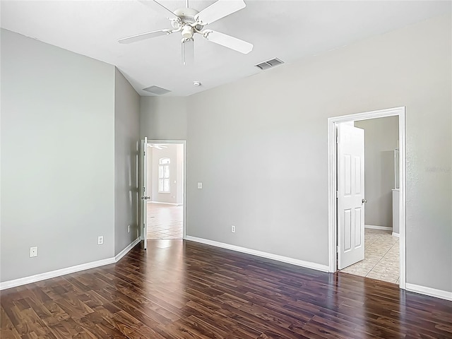 unfurnished bedroom with baseboards, a ceiling fan, wood finished floors, and visible vents