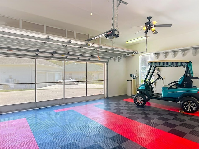 garage featuring a garage door opener and a ceiling fan