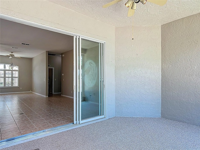 view of patio / terrace with a ceiling fan and visible vents