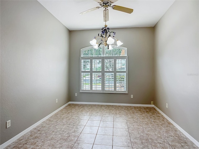 unfurnished room with baseboards, light tile patterned floors, and ceiling fan with notable chandelier