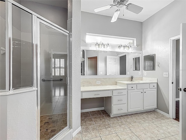 full bathroom featuring vanity, ceiling fan, and a shower stall