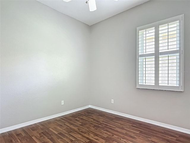 unfurnished room featuring baseboards, ceiling fan, and dark wood-style floors