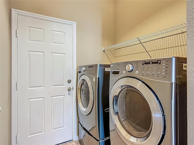laundry area with separate washer and dryer, laundry area, and light tile patterned flooring