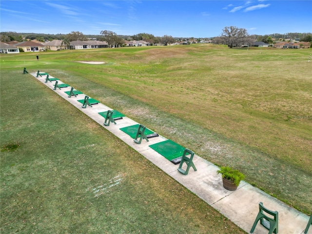 view of home's community featuring a lawn and a residential view