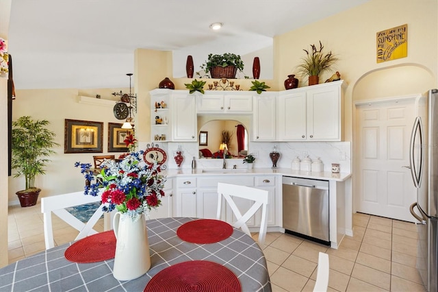 12147 SE 173rd Pl, Summerfield, FL 34491 - kitchen featuring appliances with stainless steel finishes, a sink, white cabinetry, light tile patterned floors, and backsplash