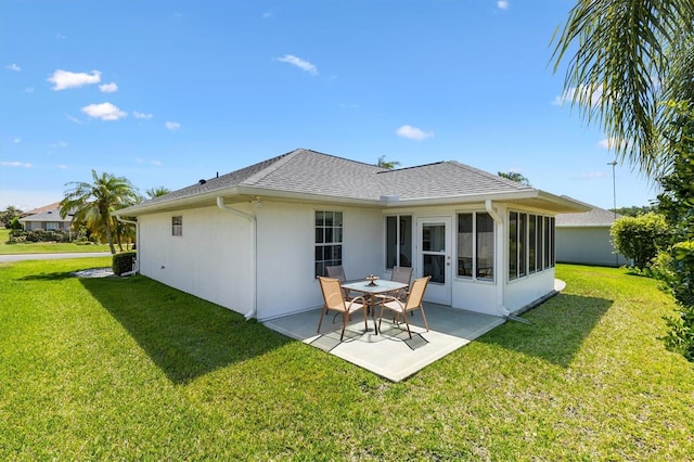 12147 SE 173rd Pl, Summerfield, FL 34491 - back of house with a lawn, a patio area, roof with shingles, and stucco siding