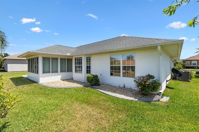 12147 SE 173rd Pl, Summerfield, FL 34491 - back of property featuring a lawn, roof with shingles, stucco siding, and cooling unit