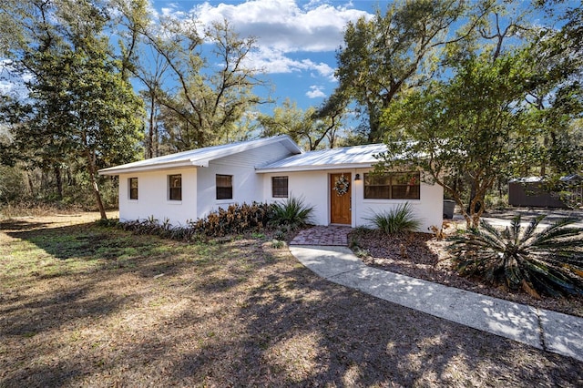 3250 SW 46th Ave, Ocala, FL 34474 - ranch-style house featuring metal roof and stucco siding