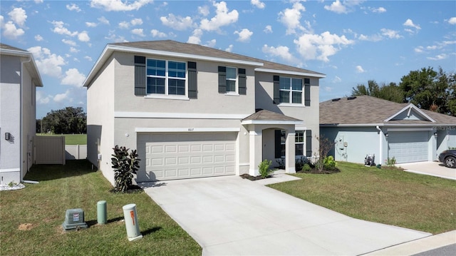 traditional-style home with a garage, stucco siding, driveway, and a front lawn