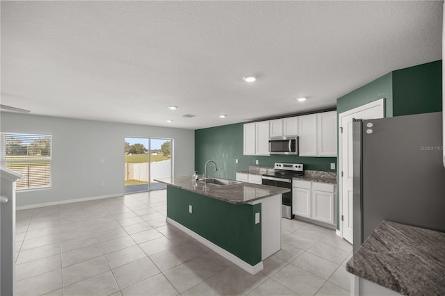 kitchen featuring a sink, stainless steel appliances, white cabinetry, recessed lighting, and light tile patterned floors