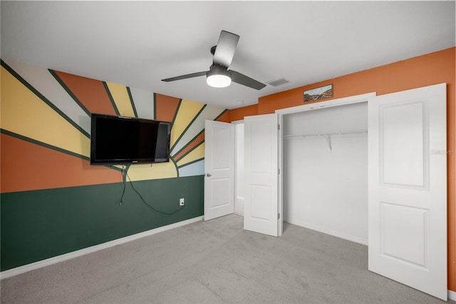 unfurnished bedroom featuring ceiling fan, visible vents, baseboards, a closet, and carpet