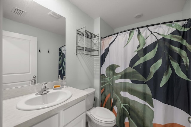 bathroom with visible vents, curtained shower, toilet, and vanity