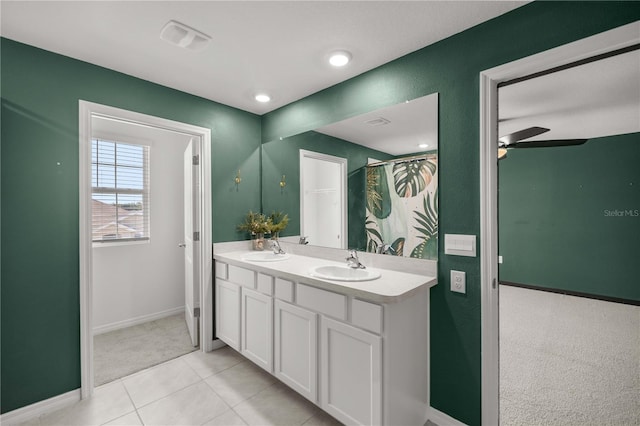 full bathroom with baseboards, a sink, a ceiling fan, and double vanity