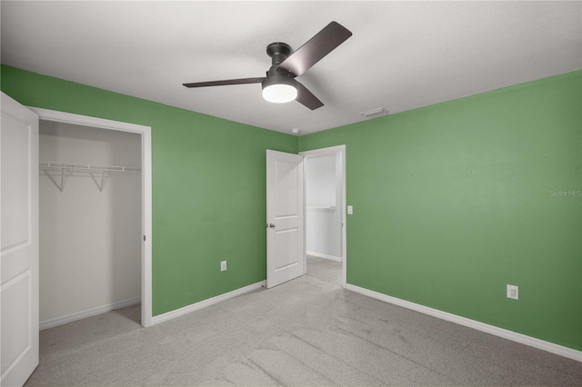 unfurnished bedroom with carpet, a ceiling fan, baseboards, visible vents, and a closet