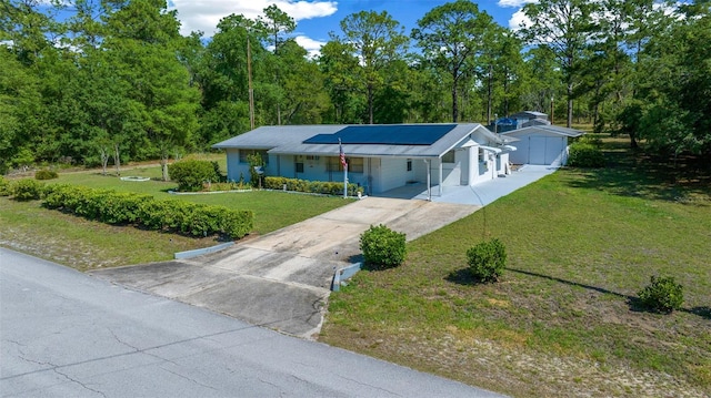 23737 NW Mallard Ave, Dunnellon, FL 34431 - ranch-style home with driveway, solar panels, and a front yard