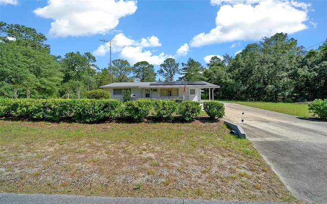 23737 NW Mallard Ave, Dunnellon, FL 34431 - ranch-style home featuring roof mounted solar panels and driveway