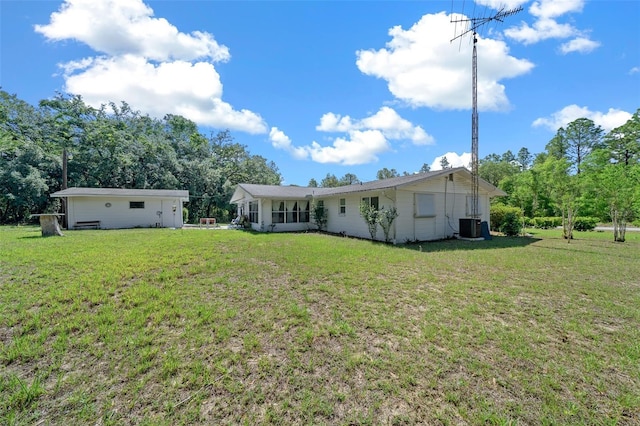 23737 NW Mallard Ave, Dunnellon, FL 34431 - rear view of house featuring a yard and cooling unit