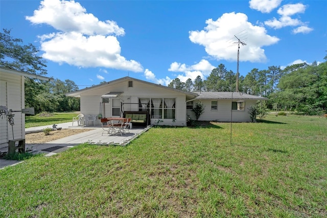23737 NW Mallard Ave, Dunnellon, FL 34431 - rear view of property featuring a lawn and a patio