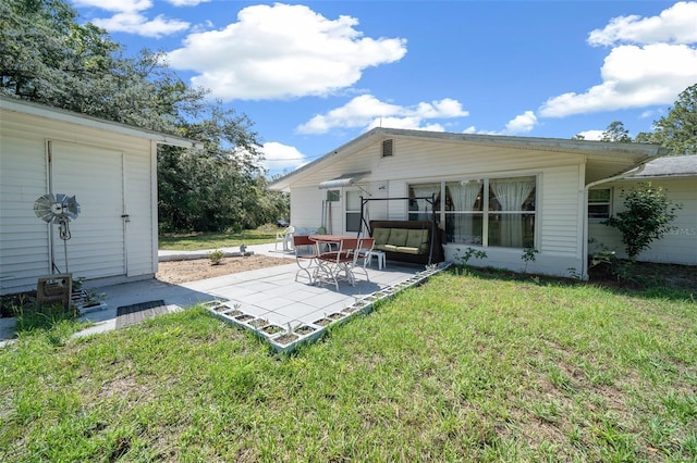 23737 NW Mallard Ave, Dunnellon, FL 34431 - back of property featuring a patio area and a lawn